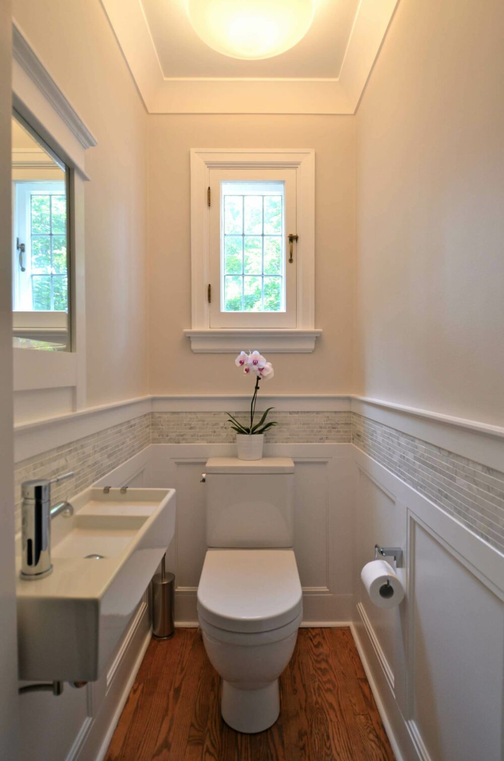 bathroom with wainscoting and tile