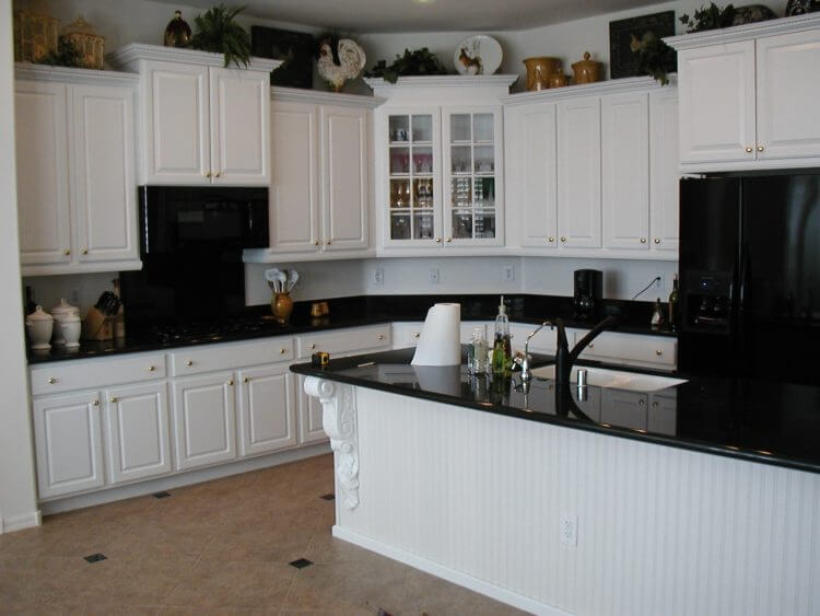 Kitchens with black and white appliances