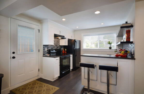 kitchens with black appliances and wood floors