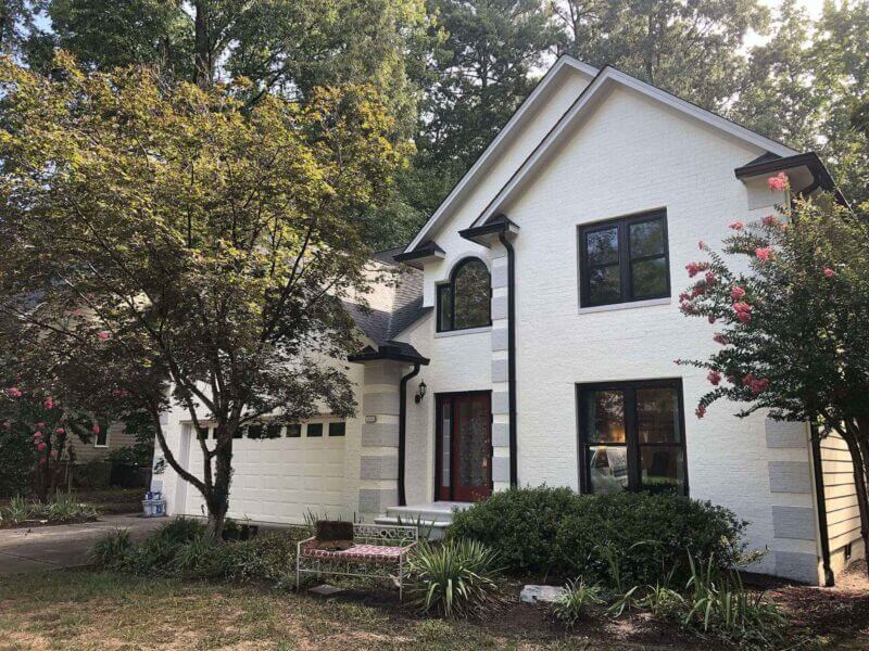 spray painting exterior brick house